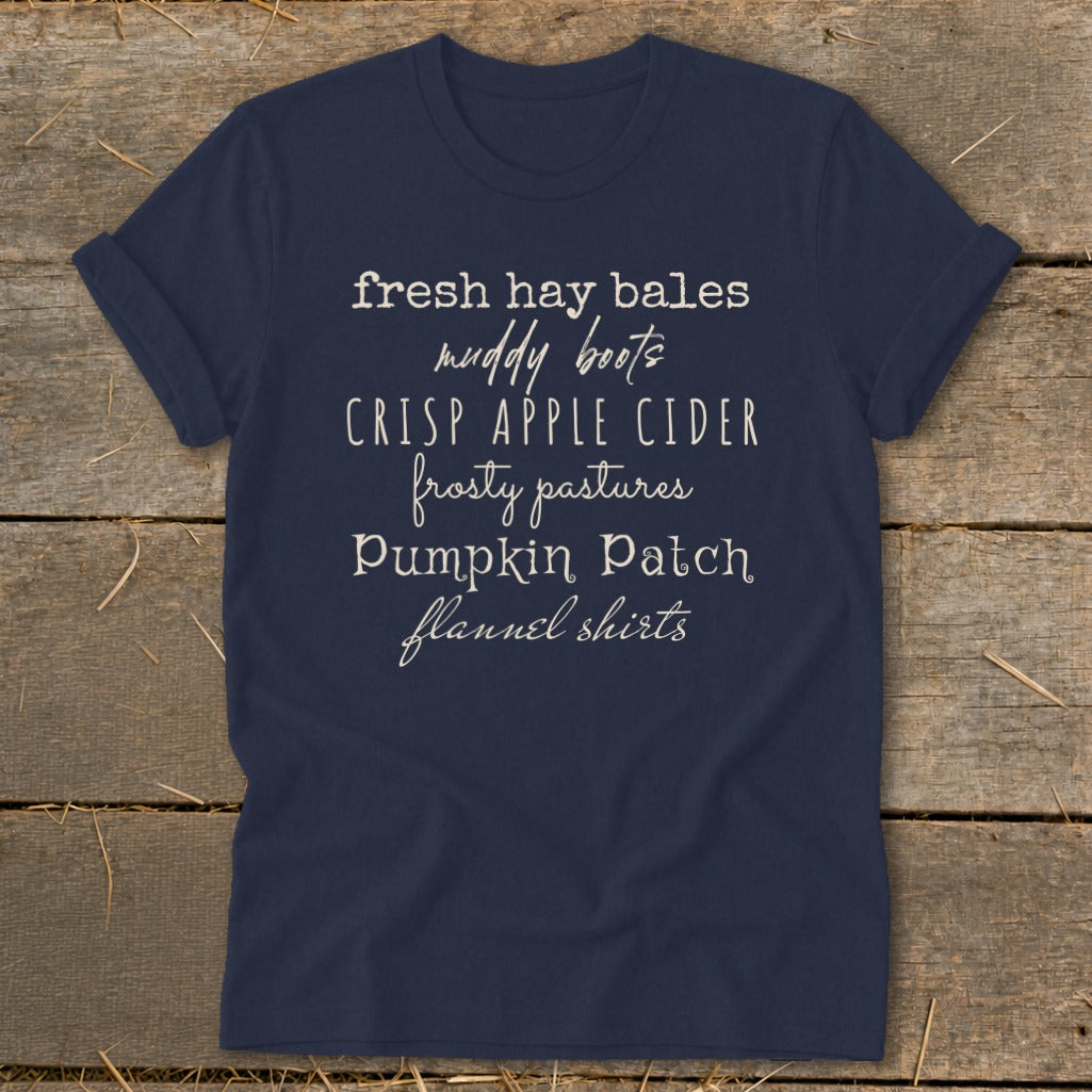 Navy t-shirt with text listing "fresh hay bales, muddy boots, crisp apple cider, frosty pastures, pumpkin patch, flannel shirts".