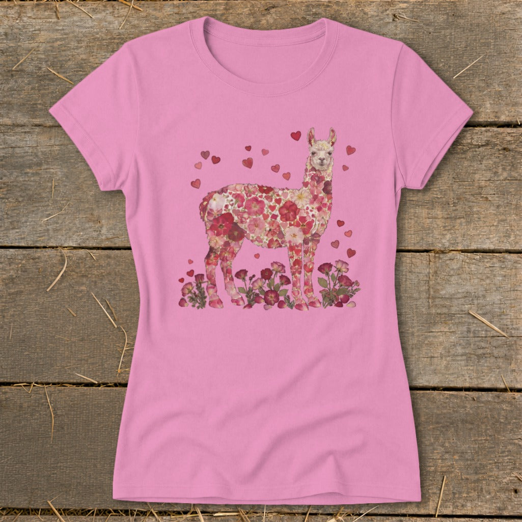 Pink t-shirt with a floral alpaca illustration surrounded by hearts and flowers.