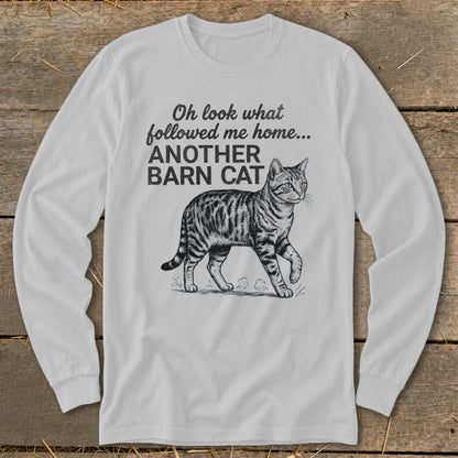 White long-sleeve shirt with text "Oh look what followed me home... ANOTHER BARN CAT" and a cat illustration.