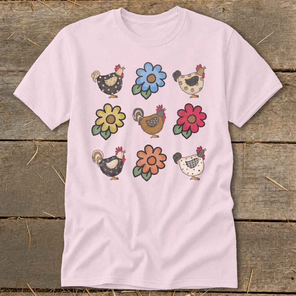 Pink t-shirt with a grid of six whimsical chickens and three colorful flowers.