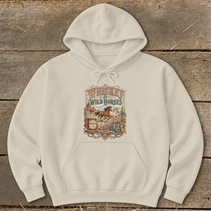 Cream hoodie with Whiskey & Wild Horses graphic featuring horses, desert, and whiskey bottle.