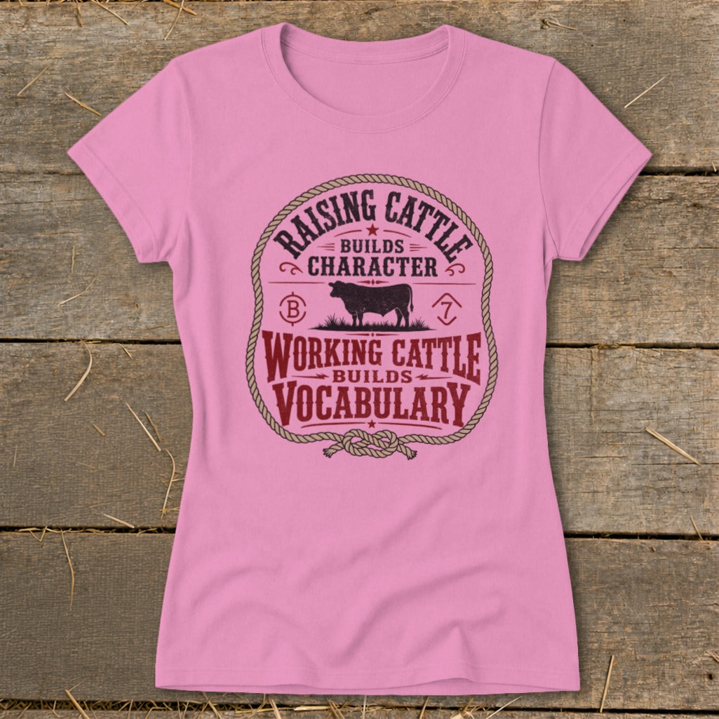 Pink t-shirt with "Raising Cattle Builds Character" and "Working Cattle Builds Vocabulary" text and cow graphic.