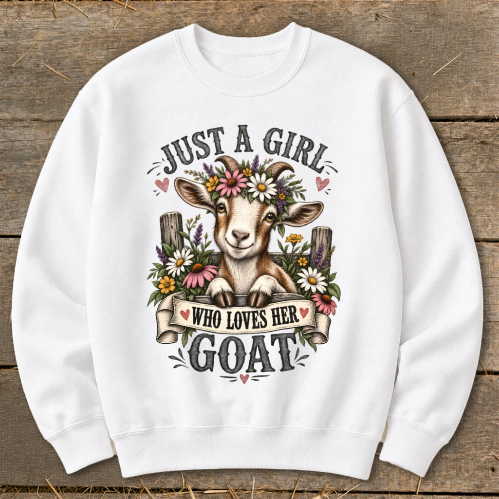 White sweatshirt with a smiling goat wearing a flower crown and the text "Just a girl who loves her goat".