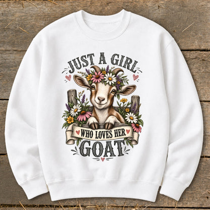 White sweatshirt with a smiling goat wearing a flower crown and the text "Just a girl who loves her goat".