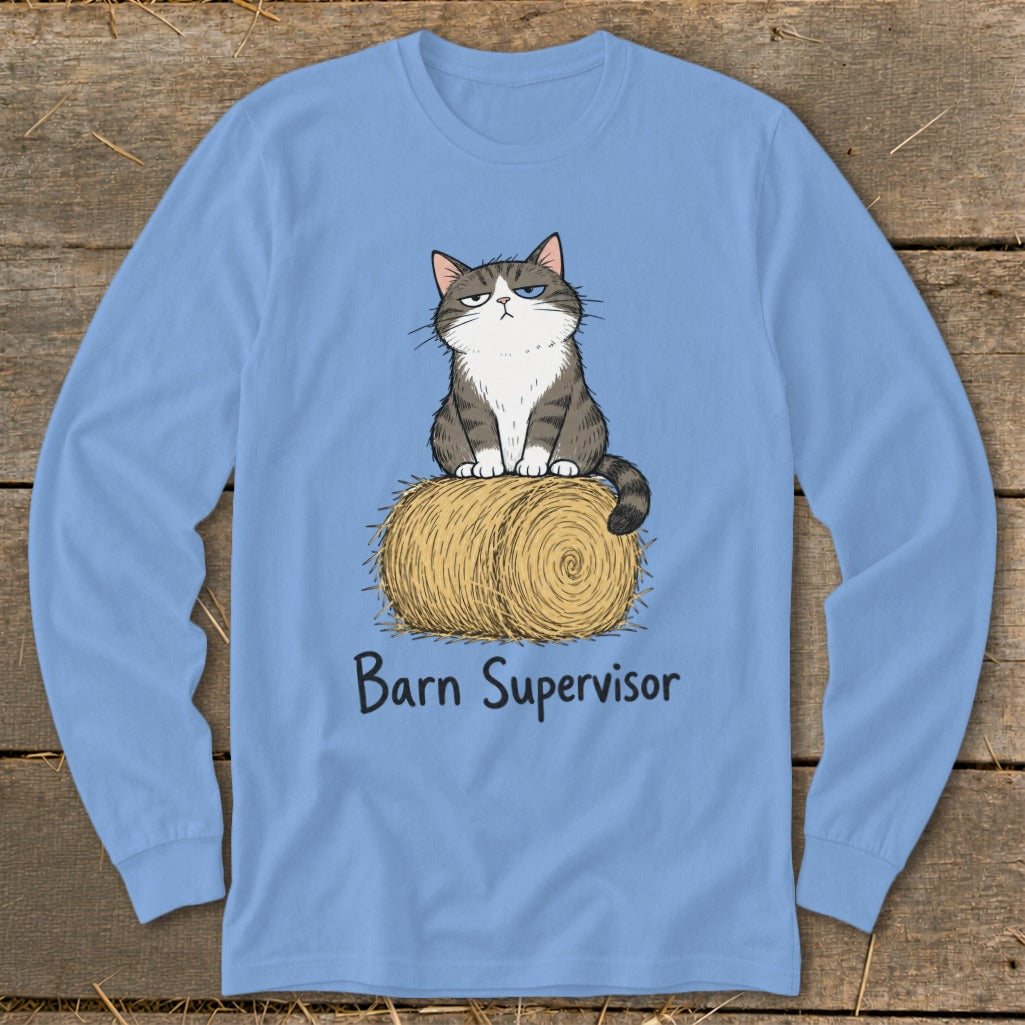 Light blue long-sleeve shirt with cartoon cat on hay bale saying "Barn Supervisor."