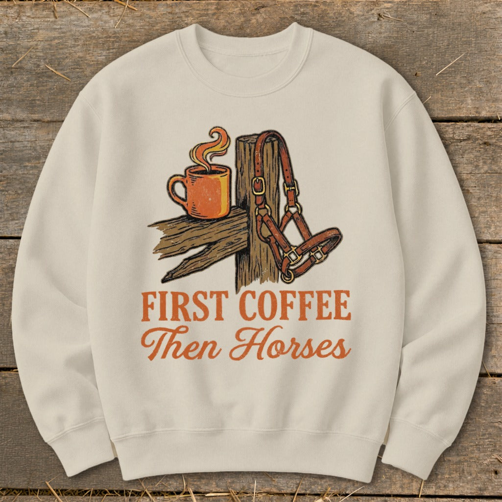 Crewneck sweatshirt with graphic of coffee cup and horse halter, reads "First Coffee Then Horses".
