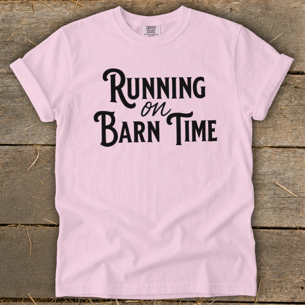 Pink t-shirt with black text that reads "Running on Barn Time".