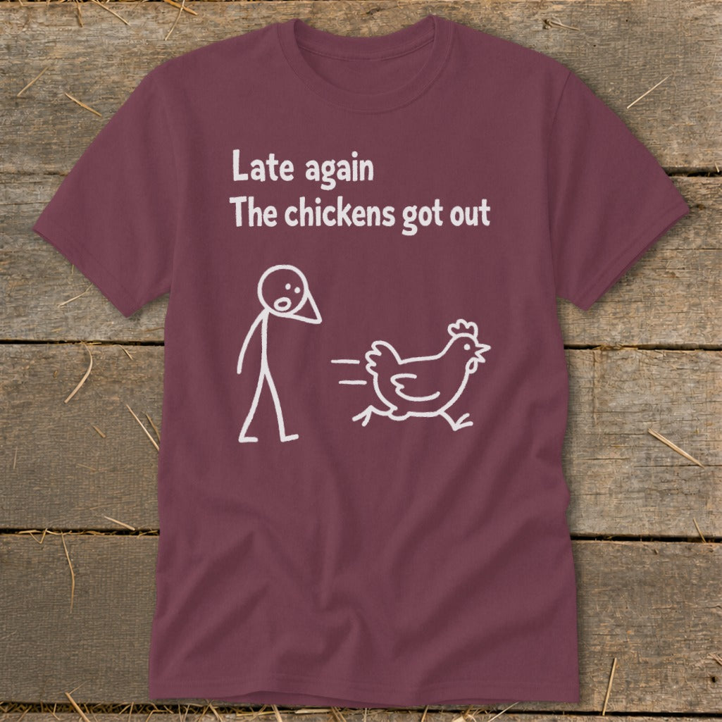 Maroon t-shirt with white text and stick figure design: "Late again The chickens got out".