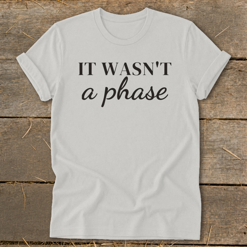 Light grey t-shirt with "IT WASN'T a phase" printed in black text.