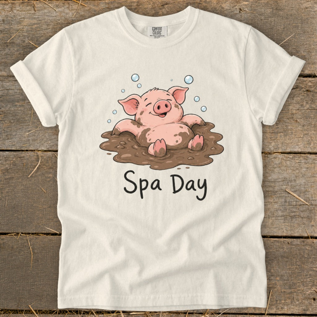 Cream t-shirt with a cartoon pig in mud spa and text "Spa Day".