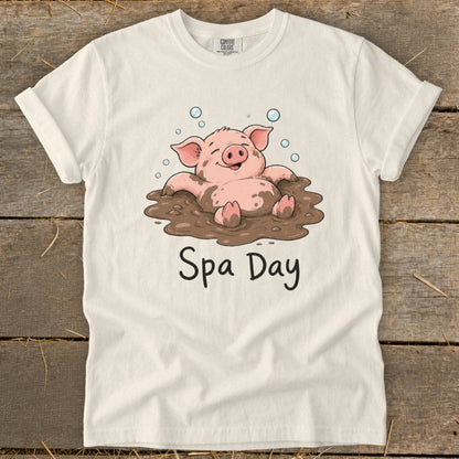 Cream t-shirt with a cartoon pig in mud spa and text "Spa Day".