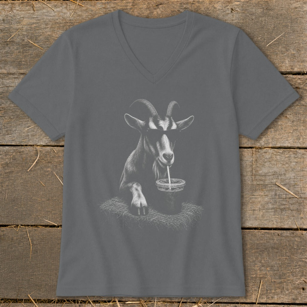 Goat wearing sunglasses drinks from a straw in a t-shirt.