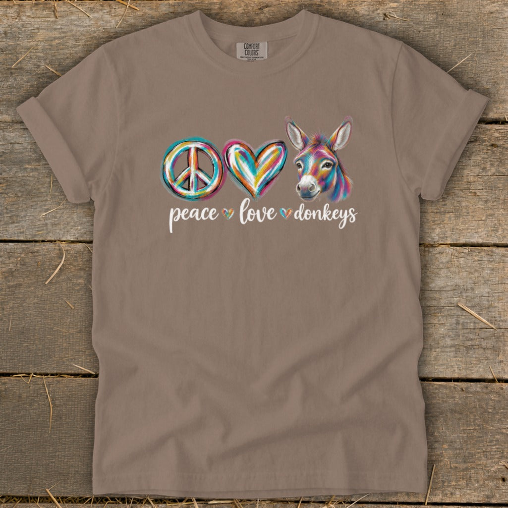 Brown t-shirt with peace sign, heart, and colorful donkey graphic.