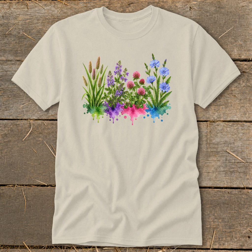 A beige crewneck t-shirt featuring a watercolor graphic of four clusters of wildflowers over colorful splatters.