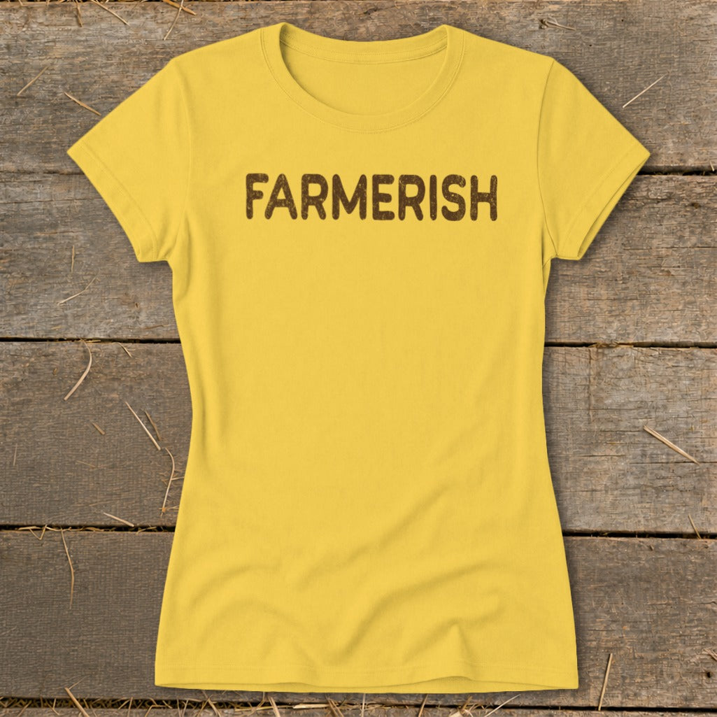 Yellow t-shirt with brown "FARMERISH" text against a wooden background.