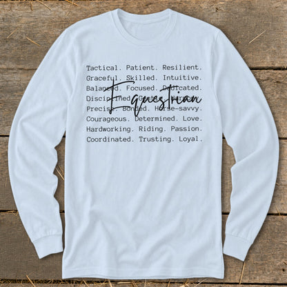 White long-sleeve shirt with list of qualities: Tactical, Patient, Resilient, Graceful, Skilled, Intuitive, Balanced, Focused, Dedicated, Disciplined, Bonded, Horse-savvy, Precise, Courageous, Determined, Love, Hardworking, Riding, Passion, Coordinated, Trusting, Loyal.