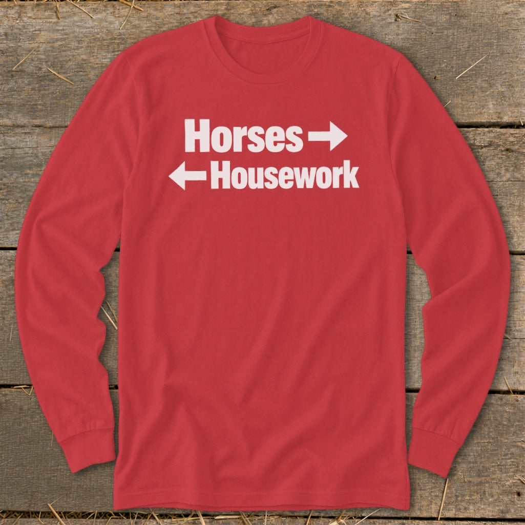 Red long-sleeved t-shirt with white text reading Horses with a right arrow and Housework with a left arrow.