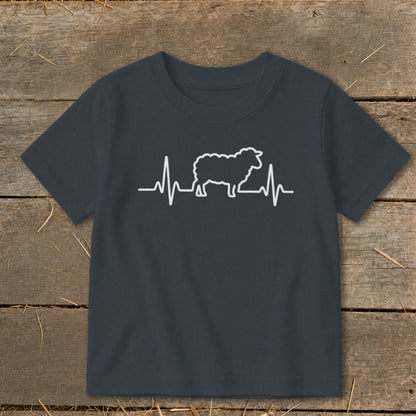 A dark gray children's t-shirt printed with a white graphic of a sheep overlaid on a heartbeat line.