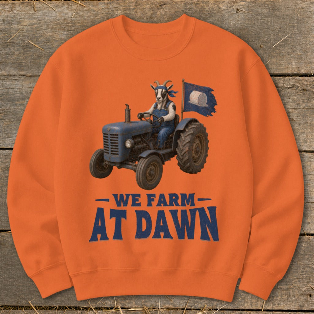 Goat wearing overalls driving a tractor with a hay bale flag, text "WE FARM AT DAWN".