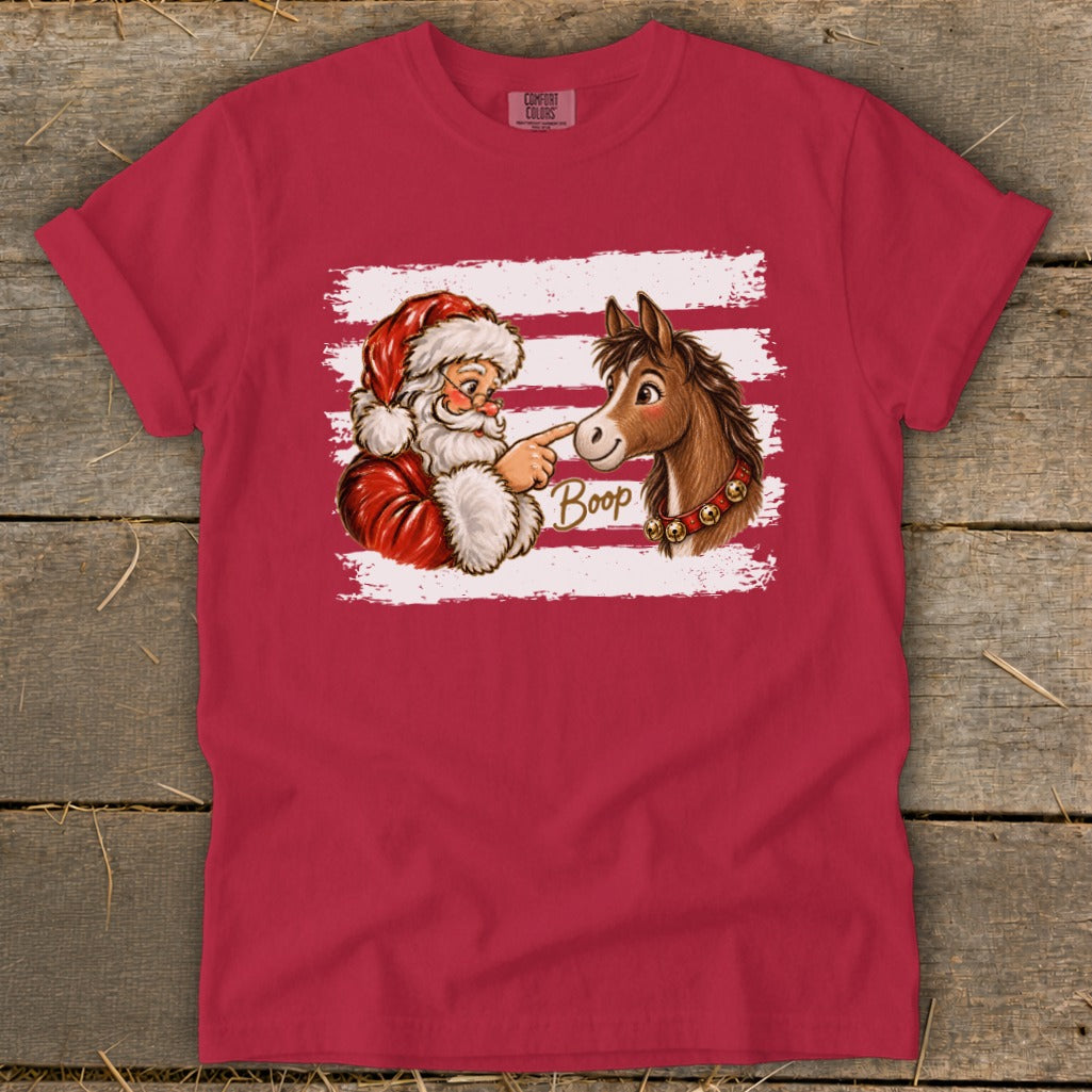 Santa Claus boops a horse on the nose with the word "Boop".