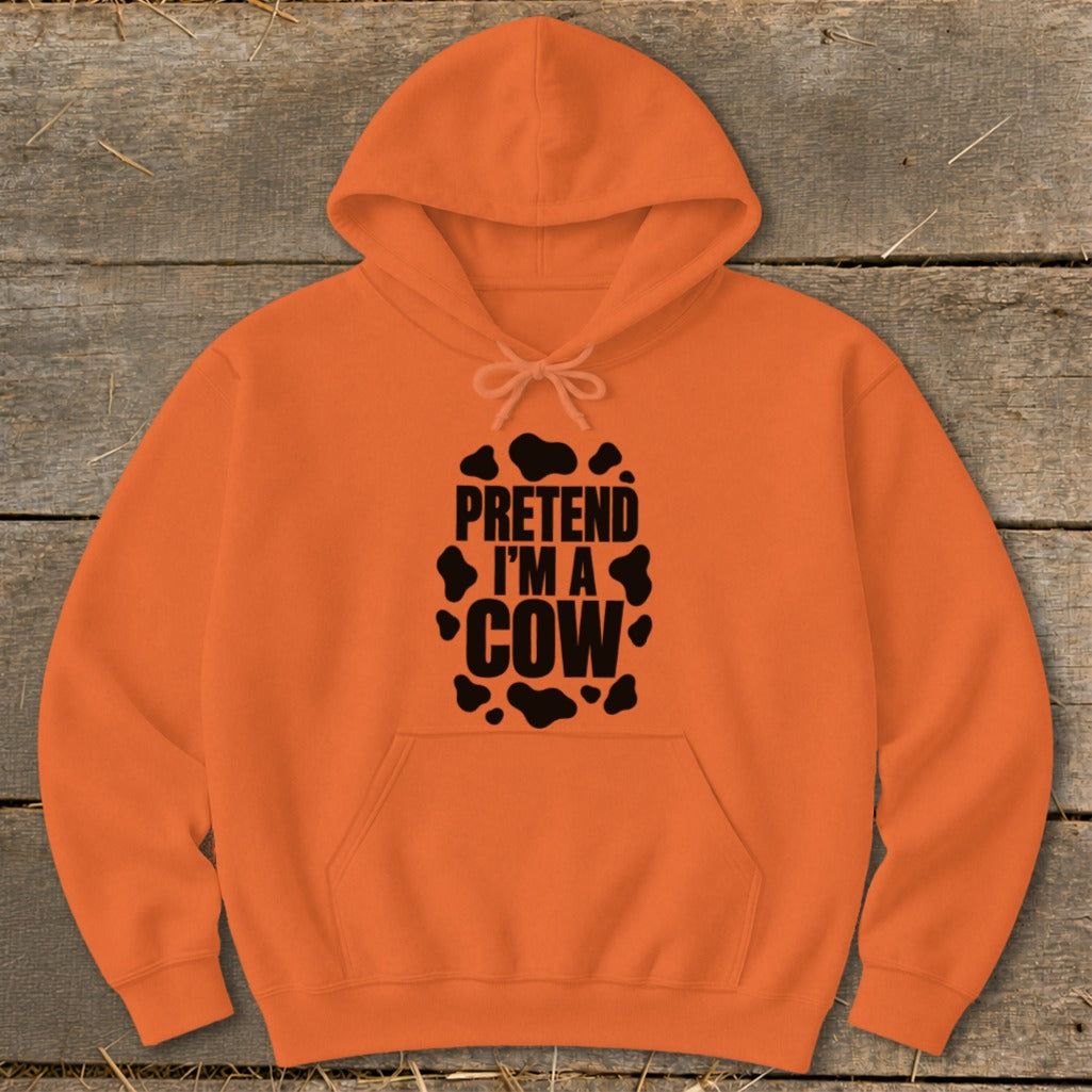 Orange hoodie with black text that says "PRETEND I'M A COW" and cow spots.