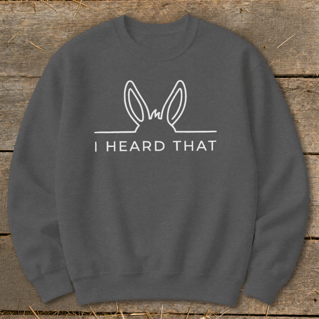 Dark grey sweatshirt with white line art of donkey ears and text "I HEARD THAT".