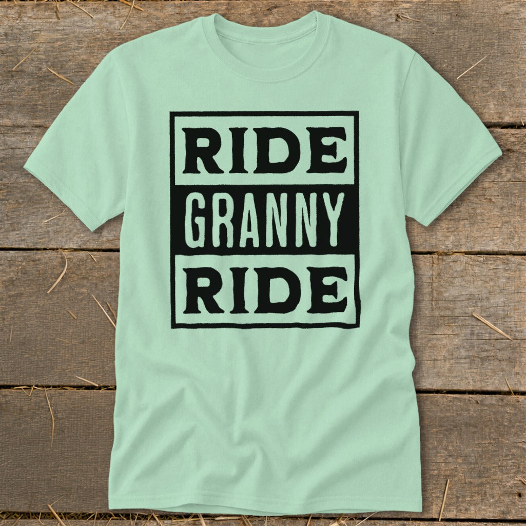 Light green t-shirt with black text reading "RIDE GRANNY RIDE" inside a rectangle.