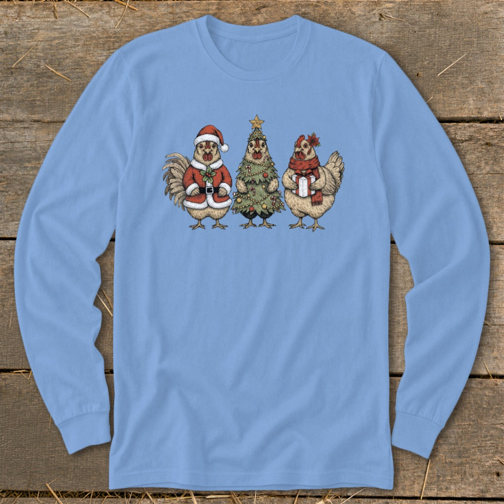Three chickens wearing festive holiday attire and holding presents, on a light blue shirt.