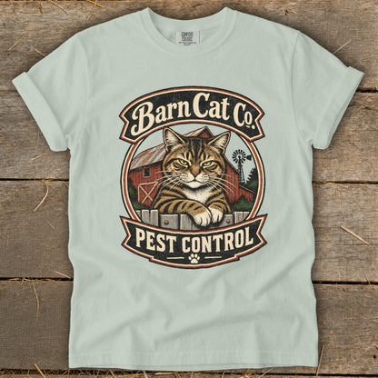 Light green crewneck t-shirt featuring a vintage graphic of a tabby cat behind a fence with Barn Cat Co. Pest Control text.
