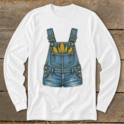 White long-sleeve shirt with denim overalls graphic holding three corn cobs.