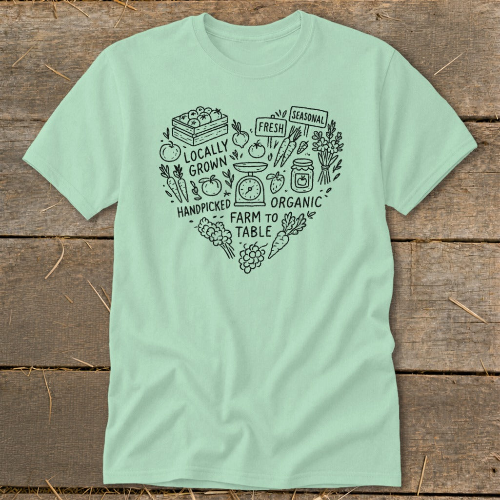 Light green t-shirt with heart-shaped farm illustration and text.
