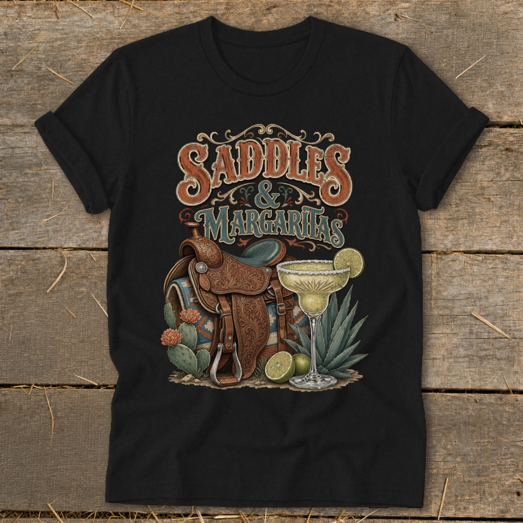 Black t-shirt graphic with "Saddles & Margaritas" text, a saddle, and margaritas.