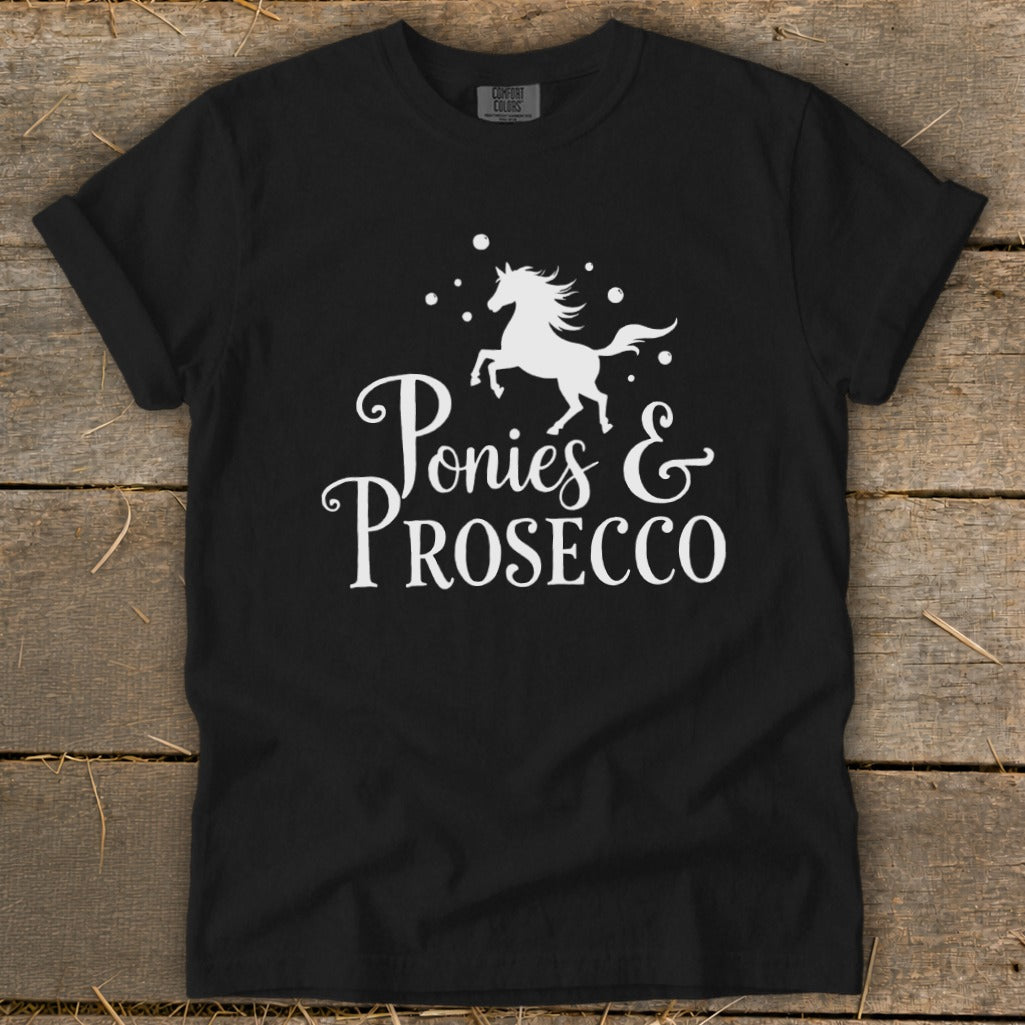 Black t-shirt with white text and horse graphic reading "Ponies & Prosecco".