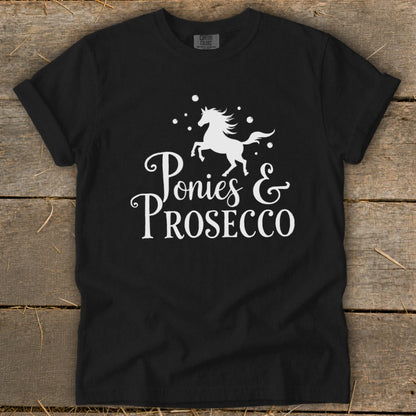 Black t-shirt with white text and horse graphic reading "Ponies & Prosecco".