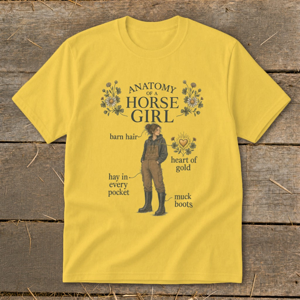 Yellow t-shirt with "Anatomy of a Horse Girl" graphic featuring a girl, barn hair, hay, heart of gold, and muck boots.