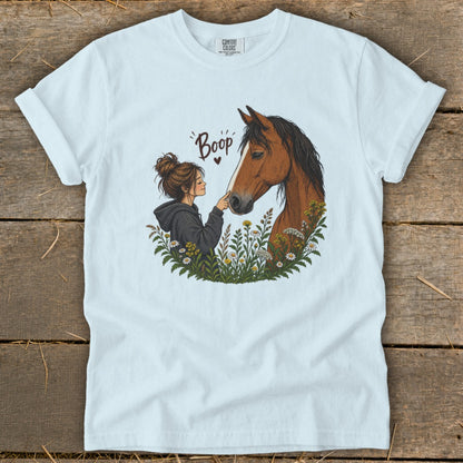 Girl with her finger touching a horse's nose, with "Boop" text.