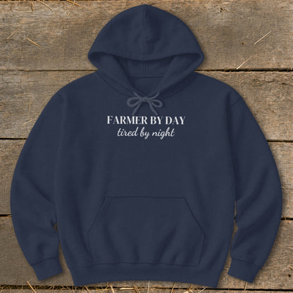Navy hoodie with white text reading "FARMER BY DAY tired by night".