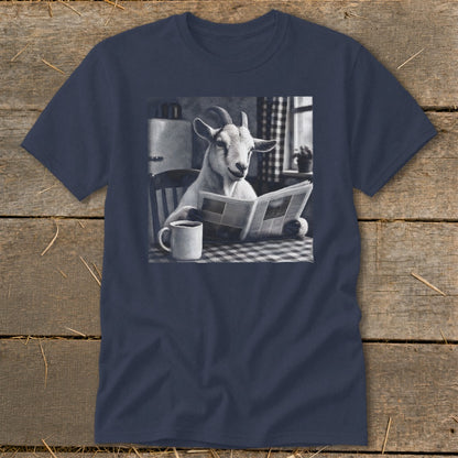 A navy blue t-shirt printed with a graphic of a goat sitting at a table, reading a newspaper next to a coffee mug.