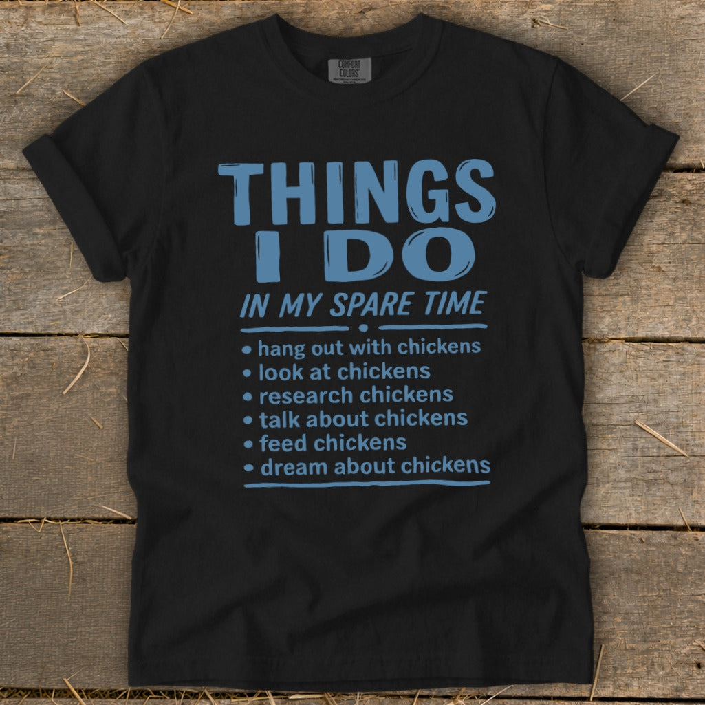 Black t-shirt with blue text listing chicken-related activities in spare time.