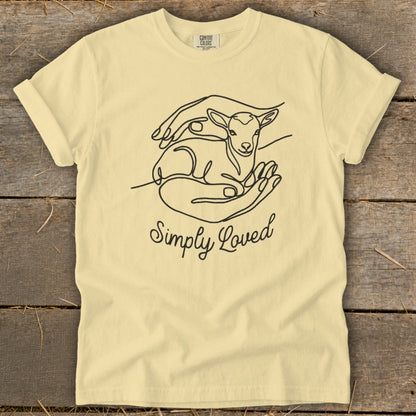 Cream t-shirt with line art of a lamb in hands and text "Simply Loved".