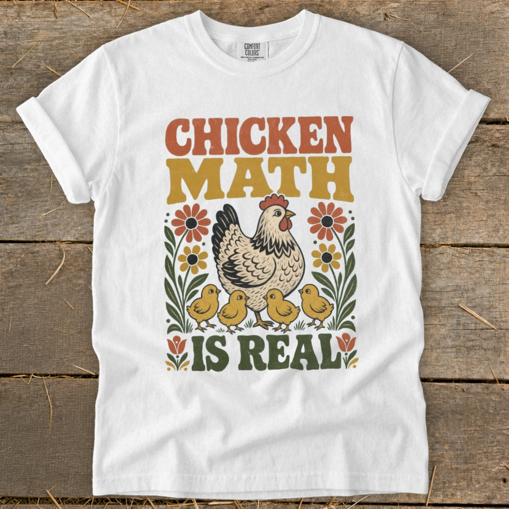 White t-shirt with "Chicken Math Is Real" text and hen with chicks graphic.