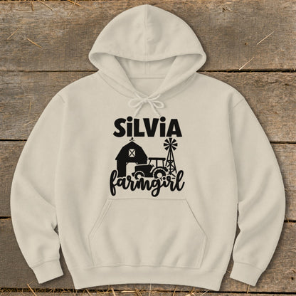 Cream hoodie with black text and graphics: "Silvia farmgirl" with barn, tractor, and windmill.