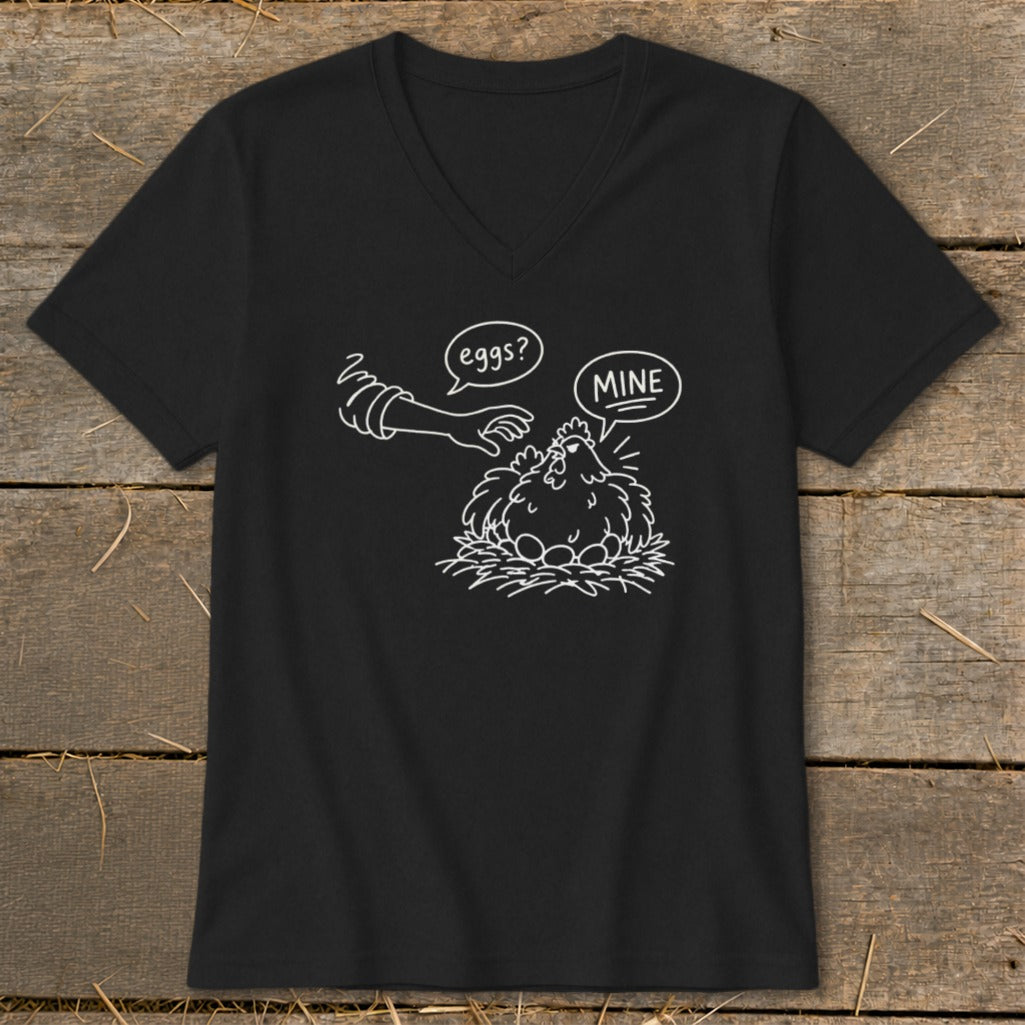 Black v-neck t-shirt with a graphic of a chicken on eggs with speech bubbles "eggs?" and "MINE".