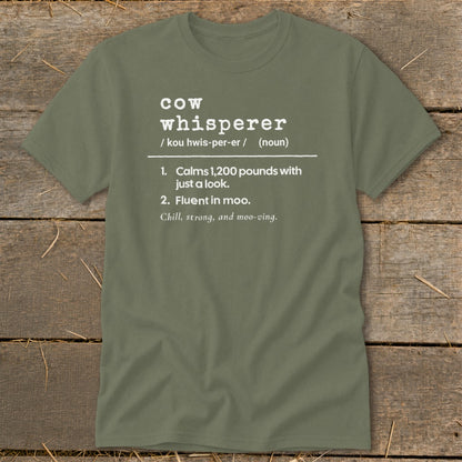 Green t-shirt with white text defining "cow whisperer" with humorous descriptions.
