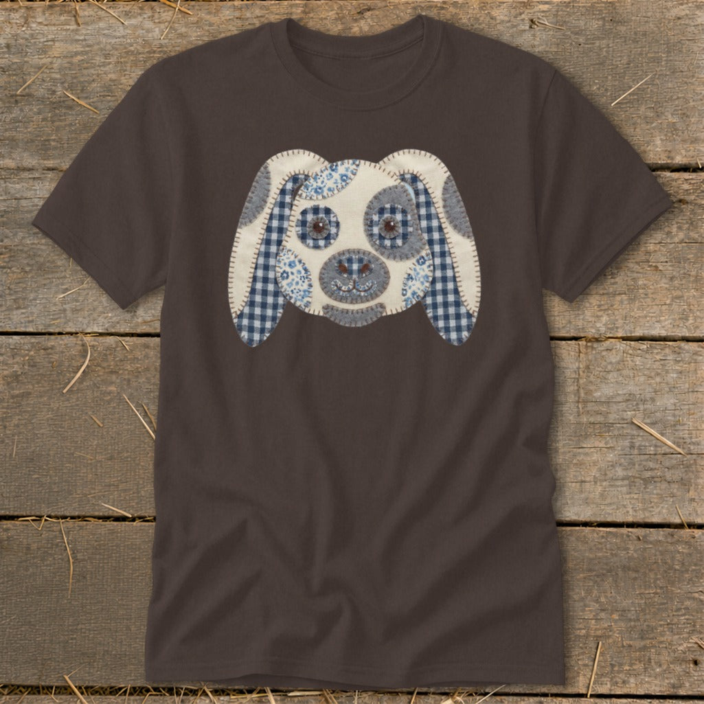 Brown t-shirt with a stitched dog face applique made of gingham and floral fabrics.