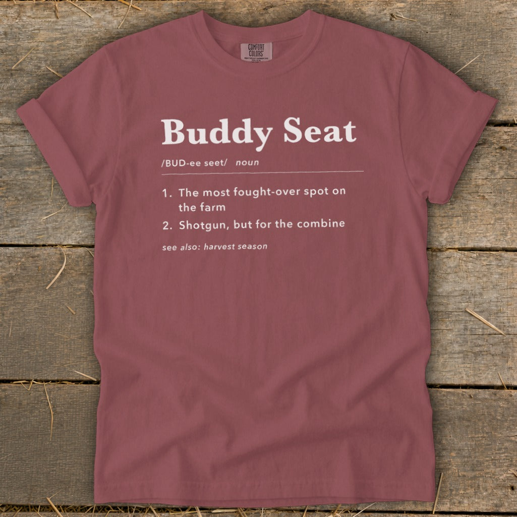 Maroon t-shirt with "Buddy Seat" definition: fought-over spot on the farm.