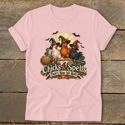 Three chickens in witch hats on a broomstick with "Chicks & Spells That's How We Roll!" text.