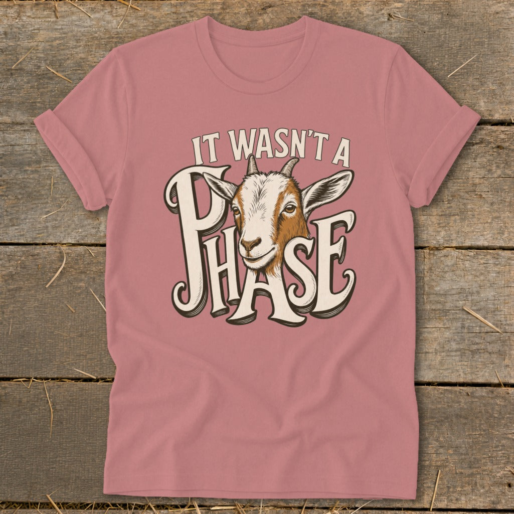 Pink t-shirt with a goat's head and the text "IT WASN'T A PHASE".