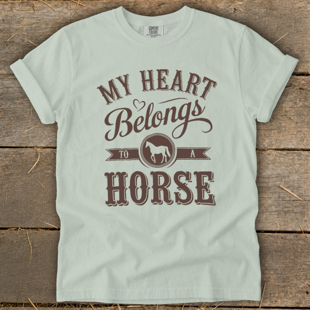 Light green t-shirt with brown text that reads "My Heart Belongs To A Horse".