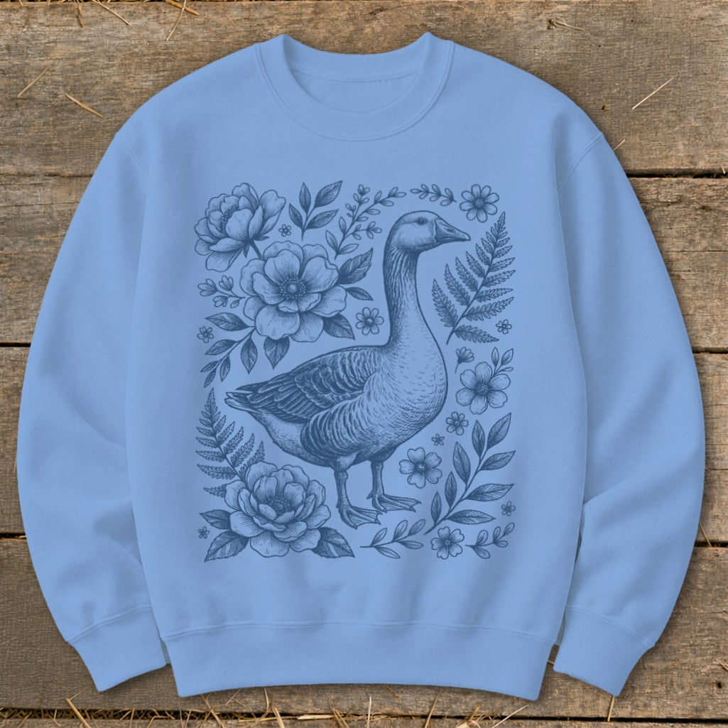 Light blue sweatshirt with a detailed goose and floral illustration in blue ink.